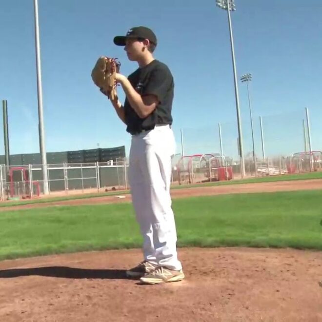 A left handed pitcher steps towards home plate but throws to first base